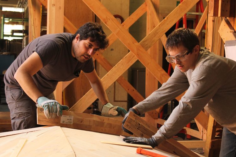 Department of Architecture Assistant Professor Tomás Méndez Echenagucia and UW Master of Science in Architecture/Design Technology student Nathan Brown construct the mass-timber room for an acoustics experiment.