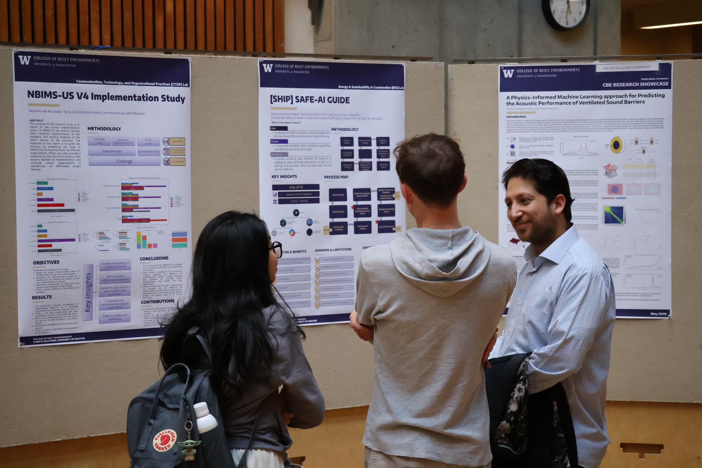 People chatting in front of research posters